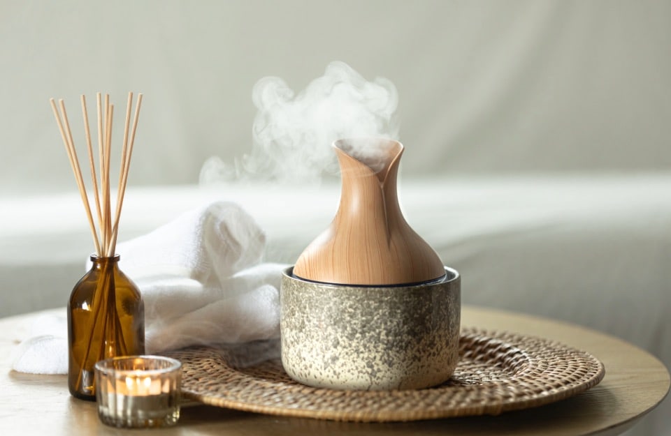 Different types of room essence diffuser: ampoule with sticks, electric diffuser and scented candle