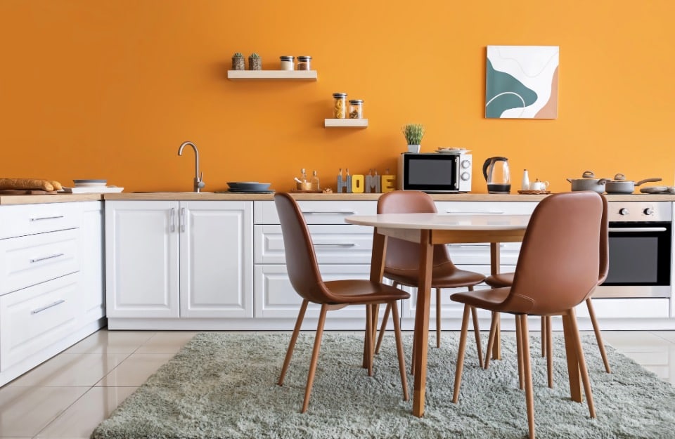 Modern kitchen with white cabinets and ochre walls