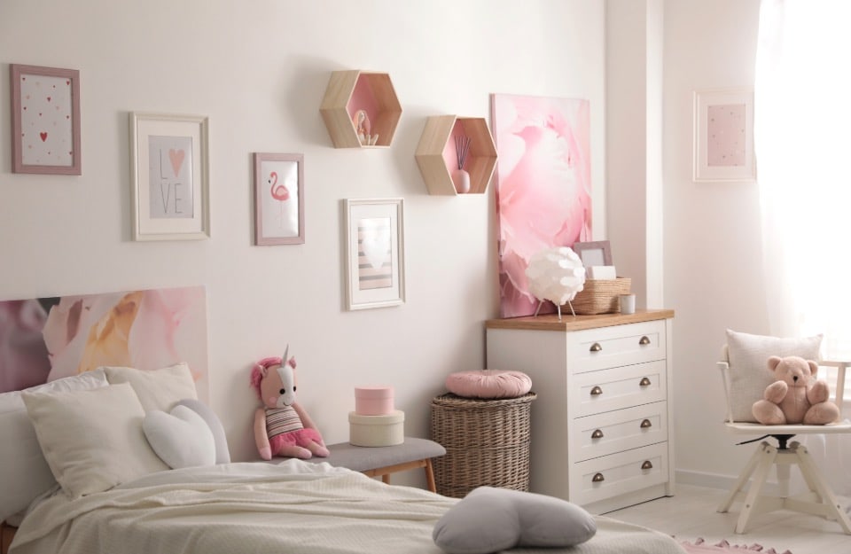 A little girl's bedroom, all in shades of white and pastel pink