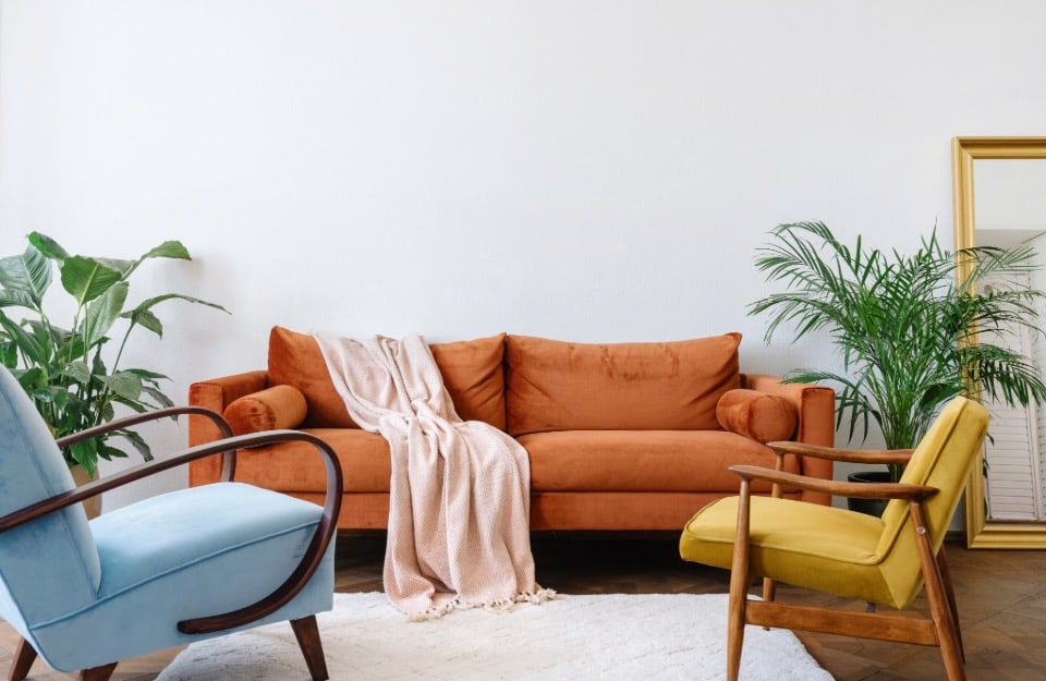 Living room with orange sofa, light blue armchair and mustard yellow armchair