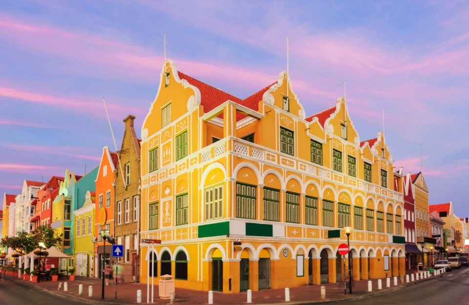 Sunset view of a street corner in Willemstad, on the island of Curaçao, with its colourful buildings in the Dutch architectural style